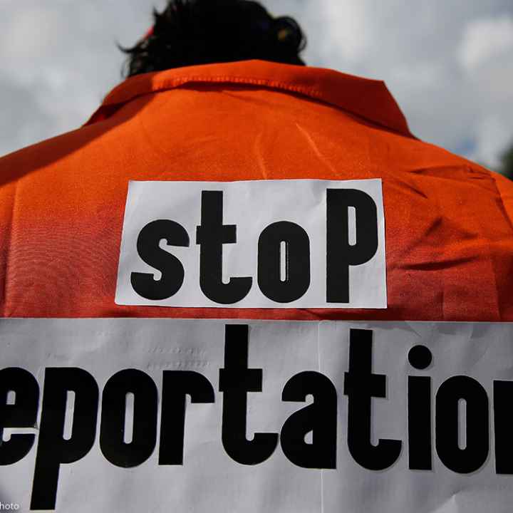 Juan Correa Villalonga wears an orange jumpsuit the says "stop deportations" on the back in protest against the ICE agents deporting Venezuelans.