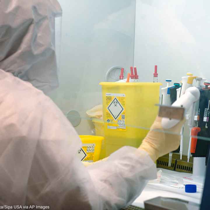 Scientists at work in high-level P3 biosafety security laboratory.