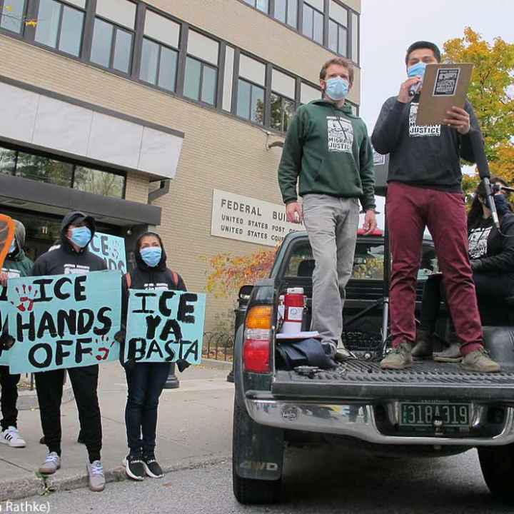 Enrique Balcazar, of Migrant Justice, an advocacy group representing immigrant farmworkers in Vermont, speaks to a crowd outside the federal court in Burlington, Vt.