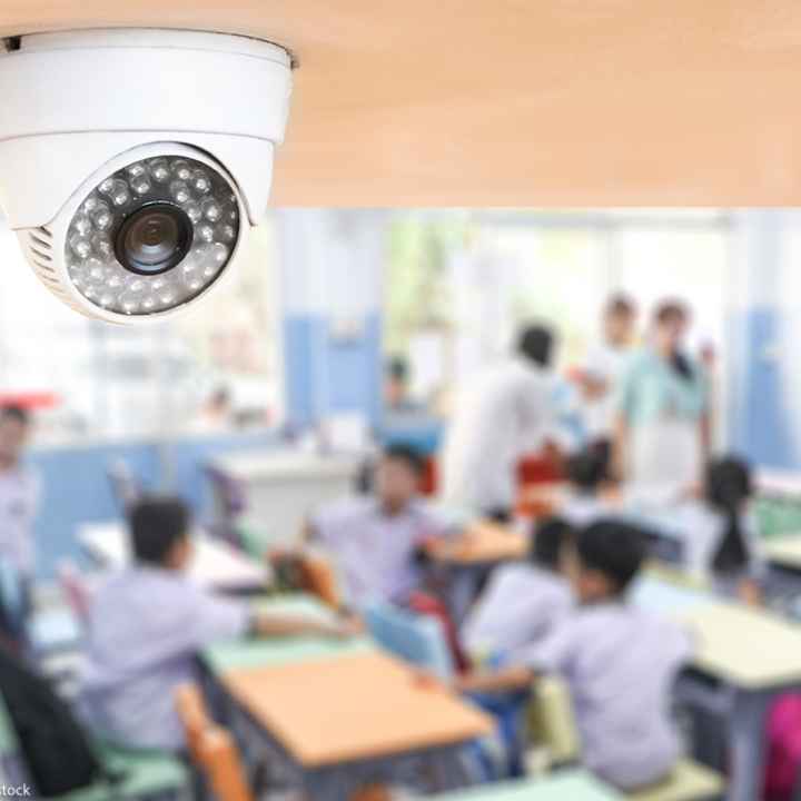 A classroom cctv camera keeping watch over students.
