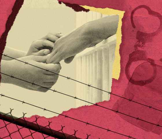 Hands reaching out to one another, behind a barbed-wire fence, with handcuffs looming in the background.